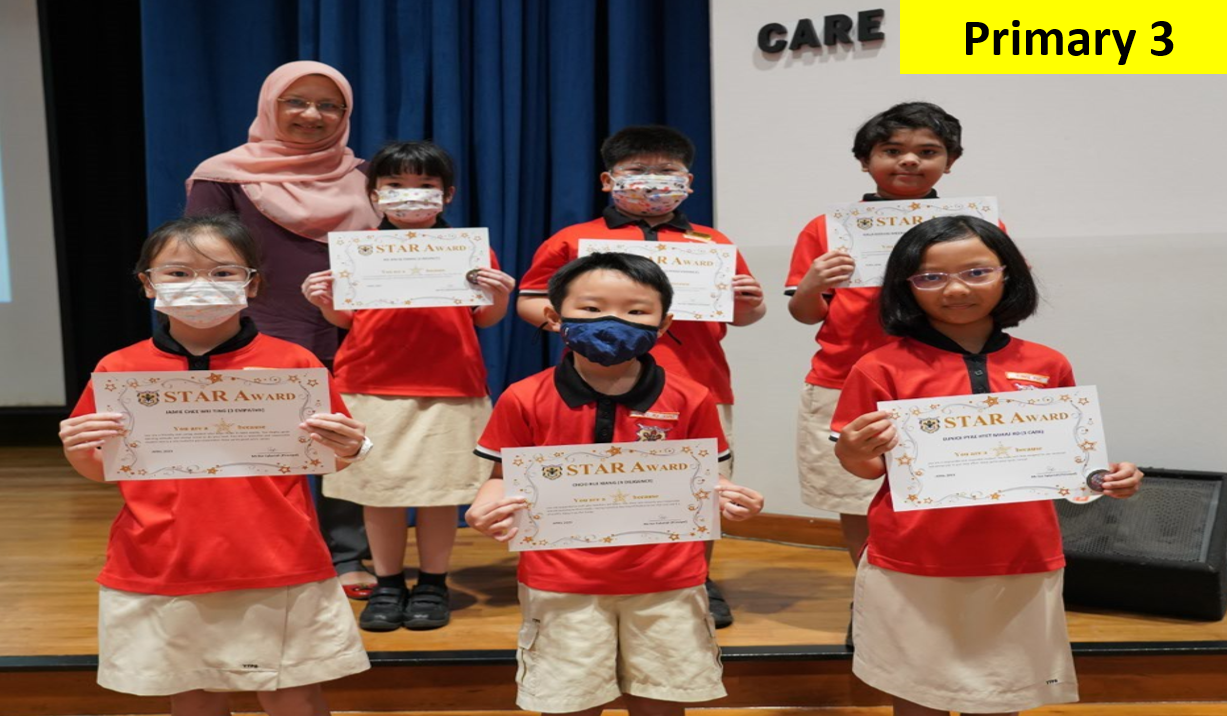 Six Primary 3 students in red uniforms hold Star Award certificates, standing with a teacher on a stage.